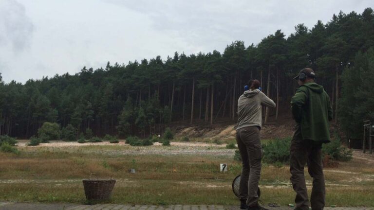 Zwei Personen im Wald beim Schießtraining
