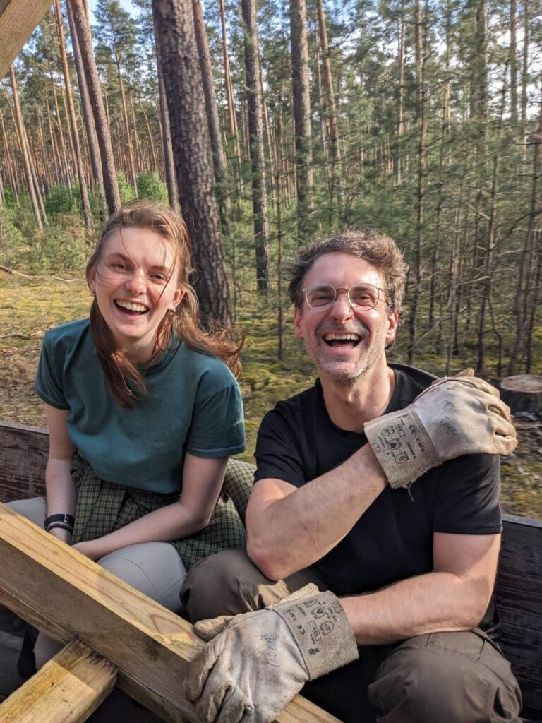 Zwei lachende Personen im Wald